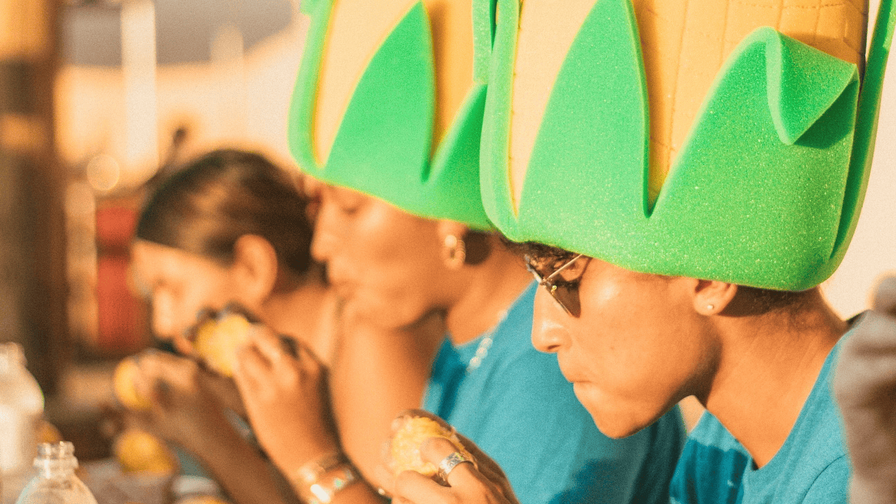 People wearing corn hat.